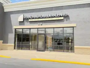 Storefront view of the Hand to Shoulder Center, with tall glass windows and door